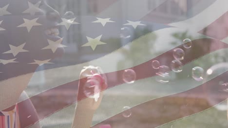 Animation-of-flag-of-usa-waving-over-african-american-mother-and-son-making-soap-bubbles