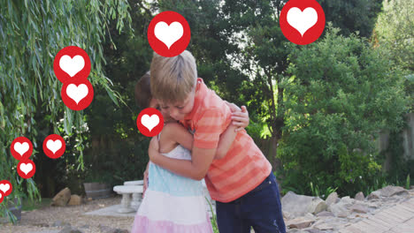 Animation-of-heart-icons-over-caucasian-sibling-hugging-in-garden