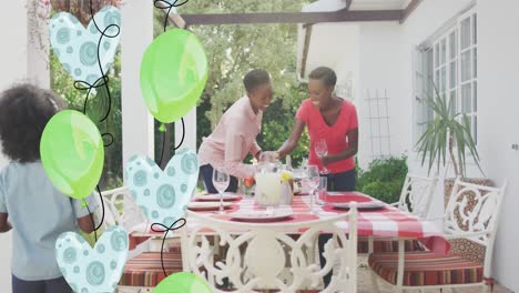 Animation-of-balloons-over-happy-african-american-family-preparing-dinner-in-garden