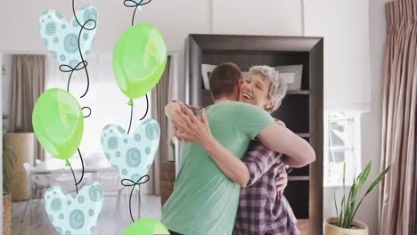 Animation-of-balloons-over-happy-caucasian-mother-and-her-adult-son-hugging-at-home