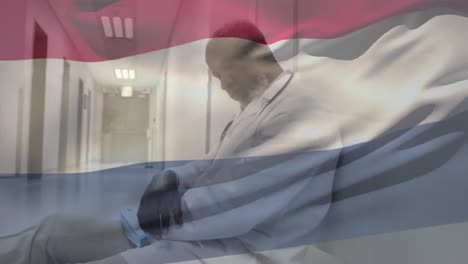 Animation-of-flag-of-netherlands-waving-over-tired-doctor-sleeping-in-hospital-corridor
