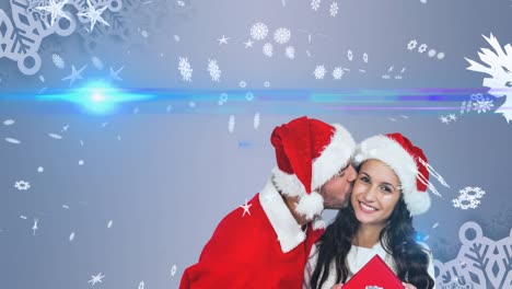 Animation-of-happy-caucasian-couple-wearing-santa-clothes-over-snow-falling