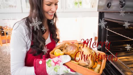 Animation-of-snow-falling-and-merry-christmas-text-over-happy-cacasian-female-preparing-meal