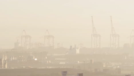 General-view-of-cityscape-with-multiple-buildings-and-shipyard-covered-in-fog