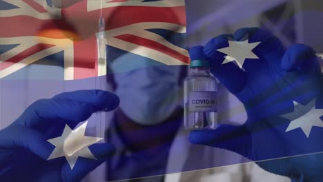 Animation-Der-Flagge-Australiens,-Die-über-Einem-Arzt-Weht,-Der-Eine-Gesichtsmaske-Trägt-Und-Einen-Impfstoff-In-Der-Hand-Hält