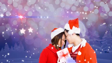 Animation-of-happy-asian-couple-wearing-santa-hats-over-winter-scenery