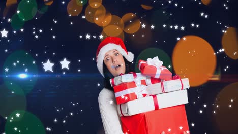Animation-of-stars-falling-over-surprised-caucasian-woman-wearing-santa-hat-keeping-presents