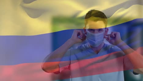 Animation-Der-Flagge-Kolumbiens,-Die-über-Einem-Kaukasischen-Arzt-Mit-Gesichtsmaske-Weht
