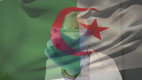 Animación-De-La-Bandera-De-Argelia-Ondeando-Sobre-Un-Médico-Con-Mascarilla-Y-Sosteniendo-La-Vacuna