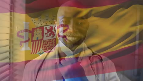 Animation-of-flag-of-spain-waving-over-doctor-wearing-face-mask