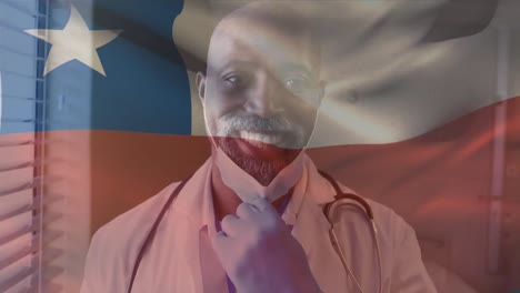 Animation-of-flag-of-chile-waving-over-african-american-doctor-wearing-face-mask
