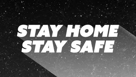 Animation-Von-Schnee,-Der-über-„Stay-Home-Stay-Safe“-Text-Auf-Schwarzem-Hintergrund-Fällt