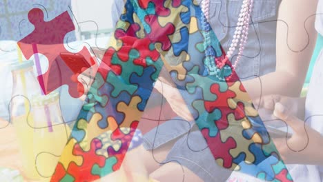 Animation-of-colourful-puzzle-pieces-ribbon-over-children-using-tablets