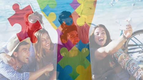 Animation-of-colourful-puzzle-pieces-hand-over-happy-friends-at-summer-beach-party