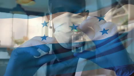 Animation-of-flag-of-honduras-waving-over-doctor-wearing-face-mask-and-holding-vaccine