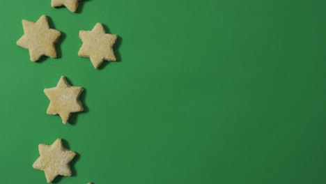 Star-shaped-christmas-cookies-and-copy-space-on-green-background