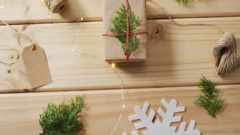 Video-of-christmas-decorations-with-presents-and-tag-on-wooden-background