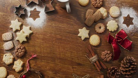 Video-of-christmas-decorations-with-cookies-and-copy-space-on-wooden-background