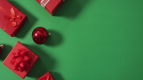 Christmas-presents-and-baubles-with-copy-space-on-green-background