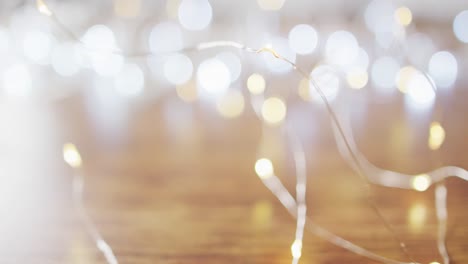 Video-of-lit-fairy-lights-christmas-decorations-and-bokeh-lights-on-wooden-background