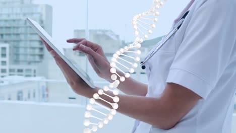 Animation-of-dna-strand-spinning-over-female-doctor-using-tablet