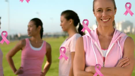 Animation-of-pink-breast-cancer-ribbons-over-group-of-smiling-women