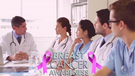 Animation-of-pink-breast-cancer-ribbon-over-group-of-discussing-doctors