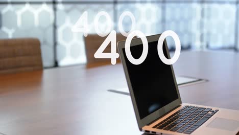 Animation-of-growing-numbers-over-laptop-on-desk