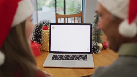 Caucasian-senior-father-and-adult-daughter-making-video-call-on-laptop-with-copy-space-on-screen