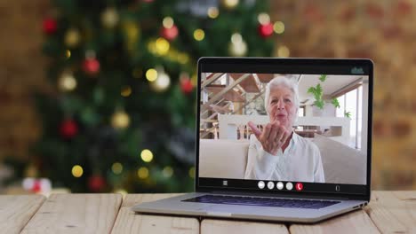 Happy-caucasian-senior-woman-on-video-call-on-laptop,-with-christmas-tree