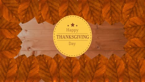 Animation-of-happy-thanksgiving-day-text-over-wooden-background-with-autumn-leaves