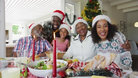 Happy-african-american-multi-generation-family-wearing-santa-hats,-taking-holiday-photo