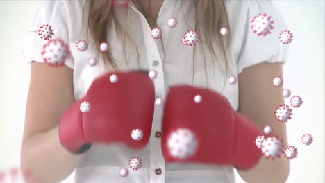 Animation-of-virus-cells-over-midsection-of-caucasian-woman-boxing