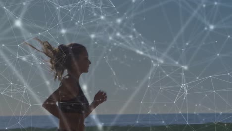 Animation-of-network-of-connections-over-fit-caucasian-woman-jogging-on-beach
