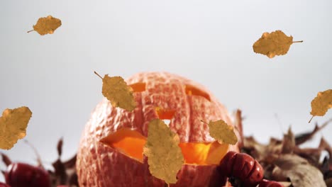 Animation-of-orange-autumn-leaves-falling-over-pumpkin