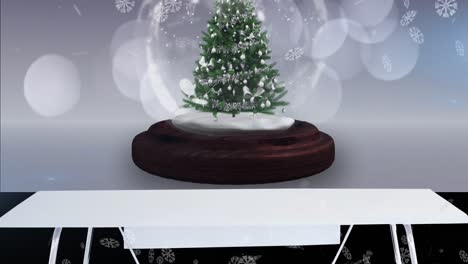 Animation-of-snow-falling-and-glowing-spots-over-snow-globe-with-tree-on-white-background