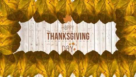 Animation-of-happy-thanksgiving-day-text-over-wooden-background-with-autumn-leaves