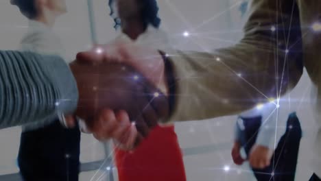 Animation-of-networks-of-connections-over-diverse-business-people-shaking-hands-in-office