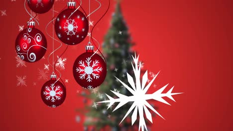 Animation-of-snow-falling-and-baubles-over-christmas-tree-on-red-background