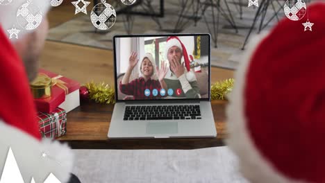 Animation-of-christmas-decorations-over-caucasian-father-and-son-in-santa-hats-on-laptop-video-call