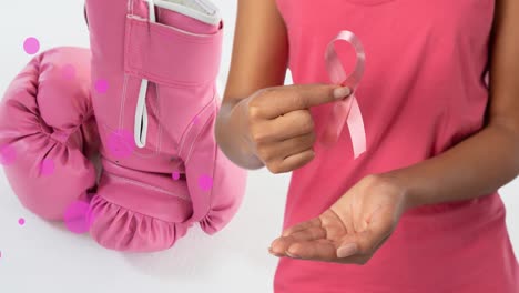 Animation-of-mixed-caucasian-holding-pink-ribbon-with-pink-boxing-gloves-on-white-background