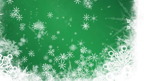 Animation-of-snow-falling-over-snowflakes-at-christmas,-on-green-background