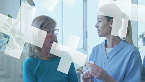 Animation-of-crosses-over-caucasian-female-doctor-and-senior-patient-talking