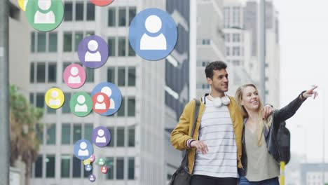 Animation-of-social-media-icons-floating-over-happy-caucasian-couple-walking-and-smiling