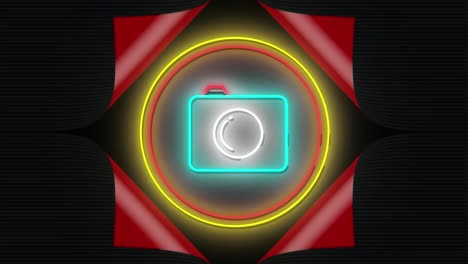 Animation-of-flashing-neon-camera-icon-in-red-and-yellow-rings-on-black-background