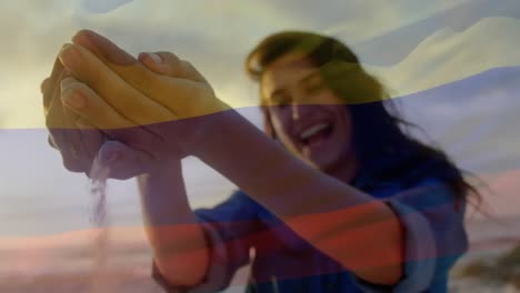 Animation-of-waving-flag-of-columbia-over-woman-having-fun-on-the-beach