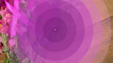 Animation-Von-Oktober-Und-Rosa-Schleife-über-Sich-Bewegenden-Violetten-Kreisen-Auf-Blumen-Im-Hintergrund
