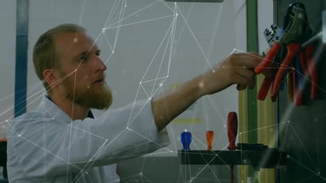 Animation-of-network-of-connections-over-caucasian-man-working-in-computer-laboratory
