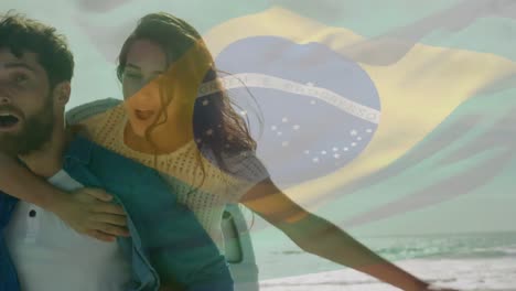 Animation-Einer-Wehenden-Brasilianischen-Flagge-über-Einem-Paar,-Das-Sich-Am-Strand-Vergnügt