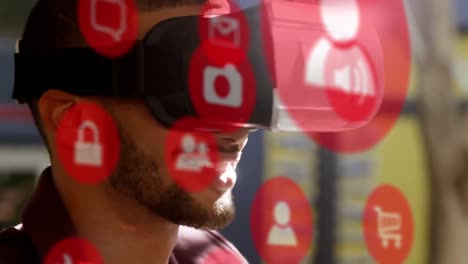 Mehrere-Rote-Digitale-Symbole-über-Einem-Mann,-Der-Im-Büro-Ein-VR-Headset-Trägt
